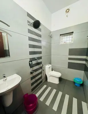 a bathroom with a white toilet and a sink at Diamond Villa Near Rajagiri Hospital in Alwaye