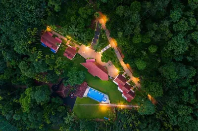 an overhead view of a house in the middle of a forest at Theyila Wayanad Premium Pool Resort in Sultan Bathery