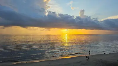 a person standing on the beach watching the sunset at The Cabana in Cherai Beach