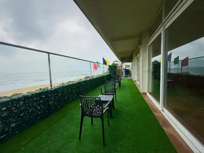 a balcony with chairs and a view of the ocean at The Cabana in Cherai Beach