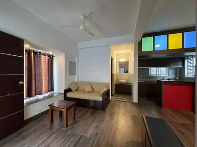 a living room with a couch and a table at DB Apartment Arimpur in Trichūr