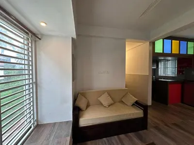 a living room with a couch and a window at DB Apartment Arimpur in Trichūr