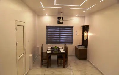 a dining room with a table and a window at Le Sancta homestay in Marayoor