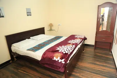 a bedroom with a bed and a wooden floor at Wild and Free Farm Stay in Ooty