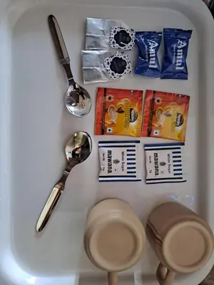 a refrigerator with utensils and other items in it at Sky Inn in Mysore