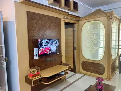 a living room with a tv on a wall at Royal King Bed Suite, Service Apartments, 1km to center , Free WI-FI in Mysore