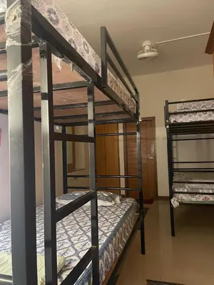a couple of bunk beds in a room at Neha's Homestay in Mysore