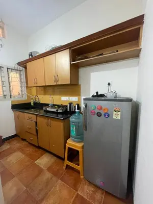 a kitchen with a stainless steel refrigerator and a sink at Neha's Homestay in Mysore