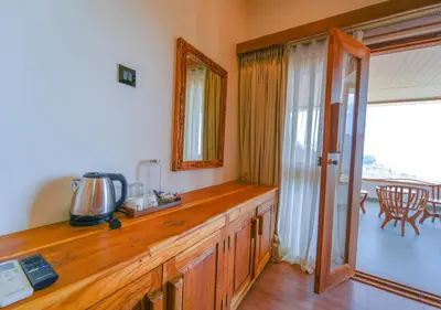 a wooden counter top in a room with a window at Silent Retreat Ooty Pool Resort by VOYE HOMES in Ooty