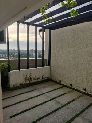 a balcony of a building with a view of the city at Urban Oasis in Trichūr