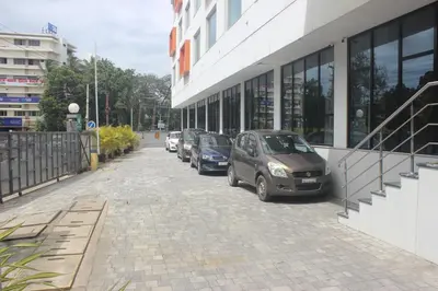 a row of parked cars parked next to a building at Zone By The Park Coimbatore in Coimbatore