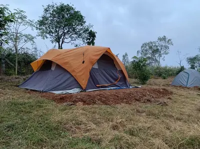 two tents are set up in a field at Wilderness Jungle Camp in Malavalli