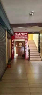a hallway with a red sign in a building at Prestige Tourist Home in Nedumbassery