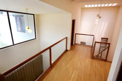 an empty hallway with a staircase and a window at Sannidhi Homes Palakkad in Palakkad