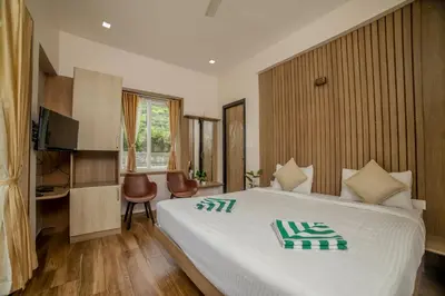 a hotel room with a bed and a television at Abhinav Nest by Xplore Indo in Kodanād