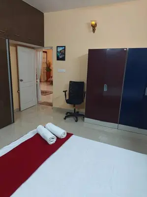 a bedroom with a bed with two towels on it at Ac 3 Bedroom House Mysore in Mysore