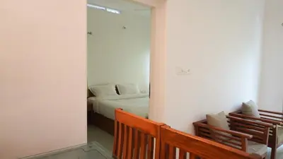 a bedroom with a bed and a mirror at Rains Valley Resort By Teal Luxury Stays in Viripara