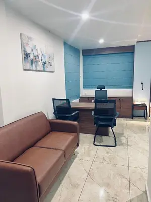 a living room with a couch and two chairs at Sahya Regency in Ottappālam