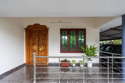 a house with plants in front of a door at Nest Villa - A Homely Heaven Near the Skies in Nedumbassery
