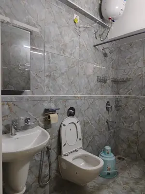 a bathroom with a toilet and a sink at 7 Elysee Homestay - Lapis - Premium 3BHK Family Flat in Trichūr