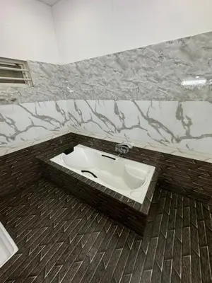 a bathroom with a toilet in the middle of the floor at River Serene Holiday home in Kizhake Chālakudi