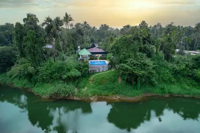 an aerial view of a house on an island in the water at River Serene Holiday home in Kizhake Chālakudi