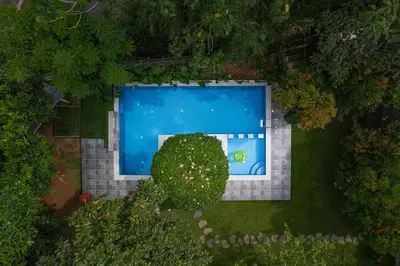 an overhead view of a swimming pool in a garden at River Wild holiday home in Athirappilly