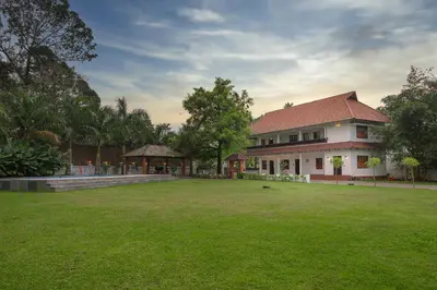 a house with a large lawn in front of it at Tamarind Heritage Holiday Home in Angamali