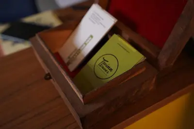 a wooden box with three books on a table at Twinn Waves By Atmos in Kozhikode