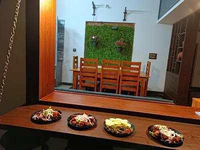 a table with three plates of food on it at Shruthi's Aarohi-Nature's Retreat Homestay in Kannur