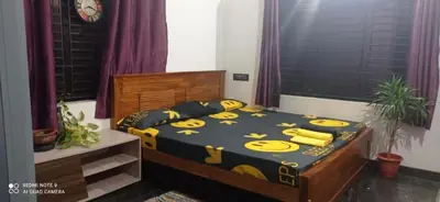 a bedroom with a bed with yellow bananas on it at Shruthi's Aarohi-Nature's Retreat Homestay in Kannur