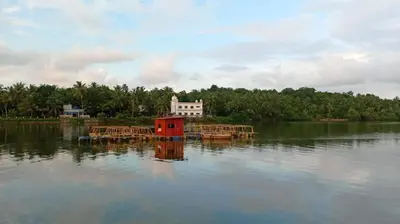a house in the middle of a body of water at Shruthi's Aarohi-Nature's Retreat Homestay in Kannur