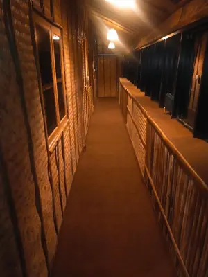 a hallway in a building at night with a flashlight at Merlys Fruit Garden in Cochin