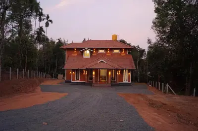 a house on a dirt road in front of a house at Vihaara Wayanad Serviced Villa in Ambalavayal