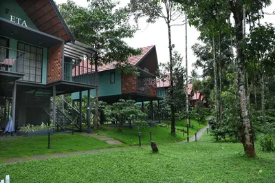 a building with a bird sitting in front of it at Bay View Suites, Vythiri, Wayanad in Wayanad