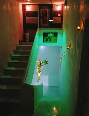 a stairway with a green light in a room at JK Home stay in Sultan Bathery
