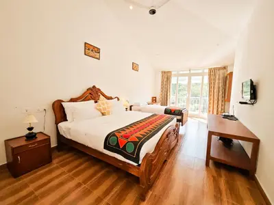 a bedroom with a large bed and a window at Ibex Resorts, Valparai Mistly in Vālpārai