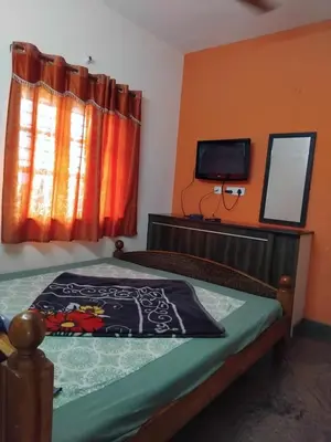 a bedroom with a bed with a television and a bedspread at Misty Meadows in Kodaikānāl