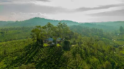an aerial view of a house on a hill at Sinna Dorai's Rotti Kadai Bungalow in Vālpārai
