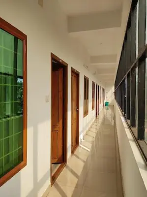 an empty hallway of a building with wooden doors at Kandengath Residency and Lodge in Mulagunnathukāvu