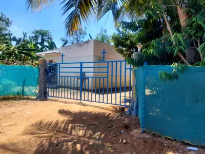 a blue gate in front of a house at GO2 Village Homestay in Pennāgaram