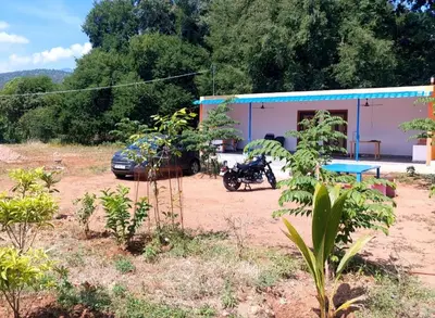 a motorcycle parked in front of a building at GO2 Village Homestay in Pennāgaram