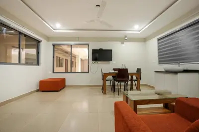 a living room with a couch and a table at Span Avenue in Kozhikode