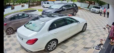 a white car parked next to two other cars at Nambiaparambil Serviced Villa in Kakkayam