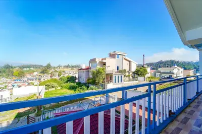 a balcony with a view of a city at Via Bala Garden in Ooty