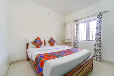 a bedroom with a bed with a colorful blanket at Via Bala Garden in Ooty