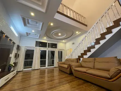 a living room with a couch and a staircase at The Misty Valley in Kodanād