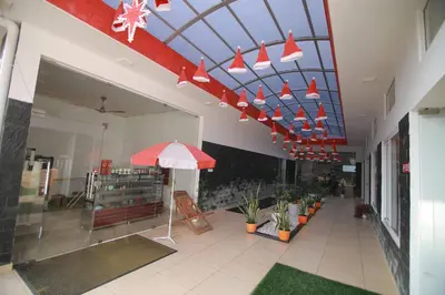a lobby with a red umbrella and a building at PitStop21 in Athirappilly