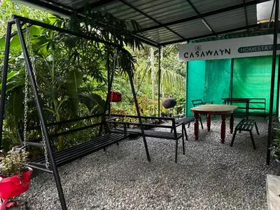 a group of chairs and a table in a room at casa wayn homestay in Sultan Bathery