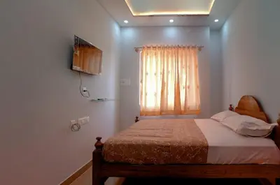 a bedroom with a bed and a window at Nagadeep Residency in Mysore